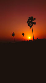 Silhouette trees against sky during sunset