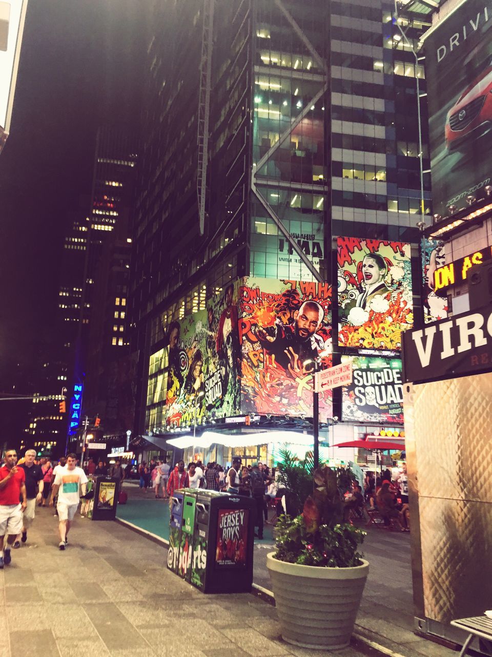 architecture, building exterior, built structure, city, men, large group of people, person, skyscraper, city life, modern, illuminated, city street, retail, travel destinations, office building, growth, outdoors, street market, crowd, tall - high