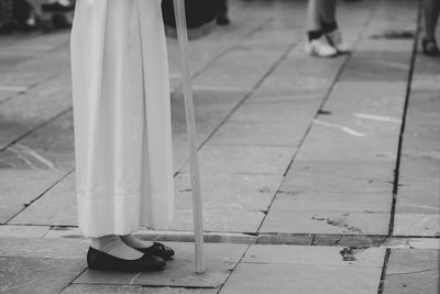 Low section of woman on footpath