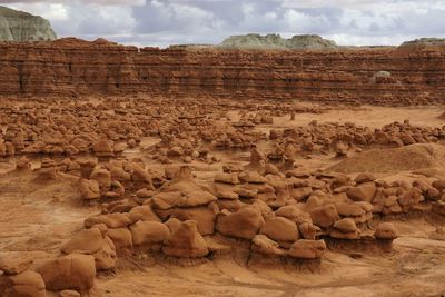 Rocks on landscape against sky