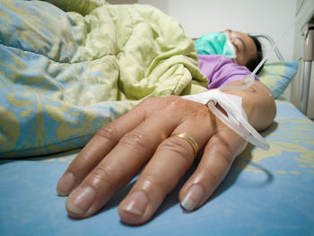 Midsection of woman lying on bed