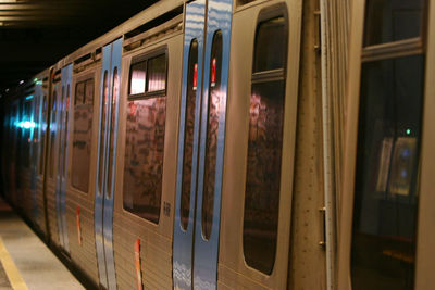 Train at railroad station platform at night