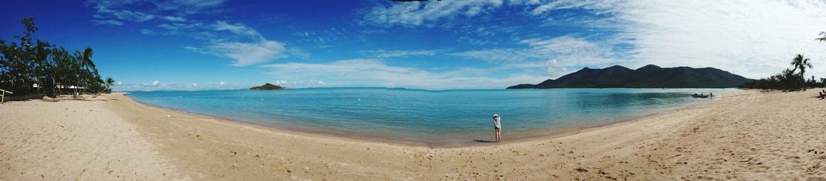 Panoramic view of beach against blue sky