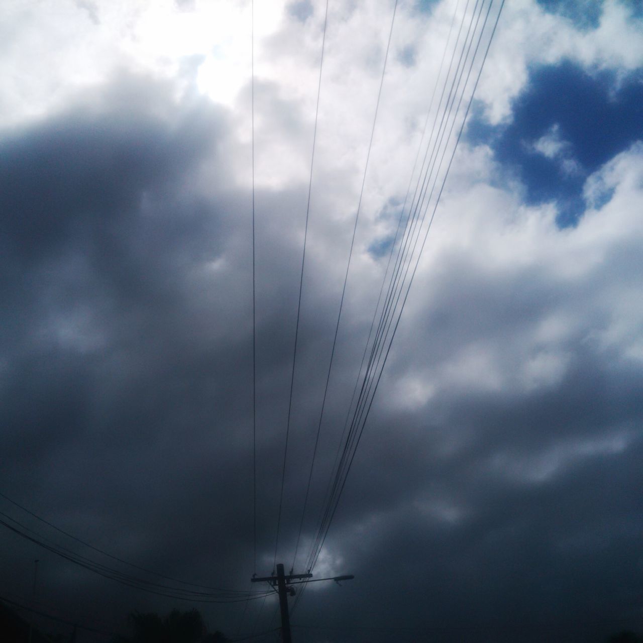 low angle view, power line, sky, electricity, connection, electricity pylon, cloud - sky, power supply, cable, cloudy, technology, fuel and power generation, silhouette, cloud, outdoors, nature, dusk, no people, weather, complexity