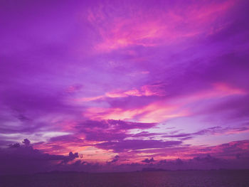 Scenic view of sea against dramatic sky during sunset
