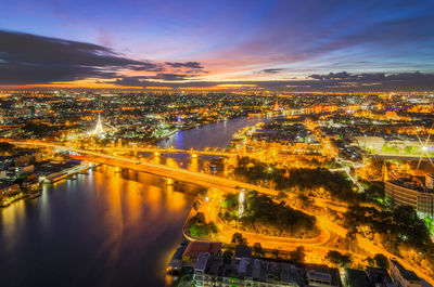 High angle view of illuminated buildings against sky at night