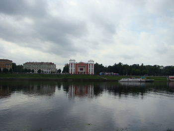 Reflection of building in lake against sky