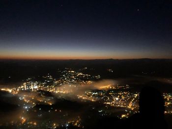 High angle view of illuminated buildings in city at night