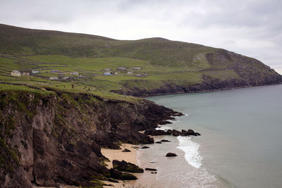 Scenic view of sea and mountains against sky