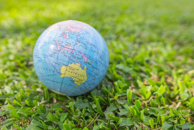 Close-up of crystal ball on grass