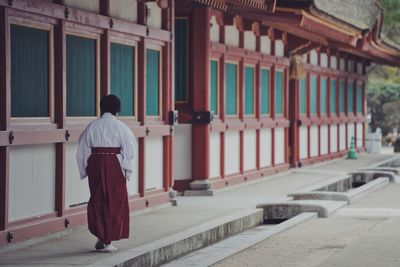 Rear view of man standing outside building