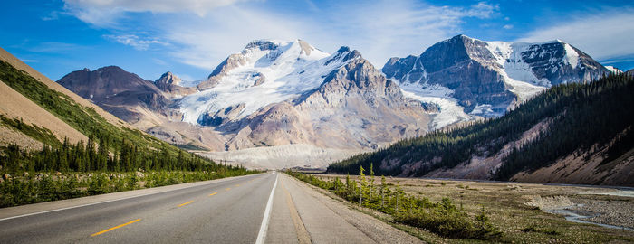 Road amidst mountains against sky