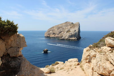 Panoramic view of rocks and sea against sky