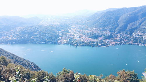 High angle view of lake and mountains against sky