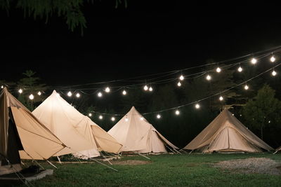 Tent in field against sky at night