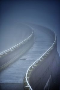 Aerial view of bridge over sea against sky