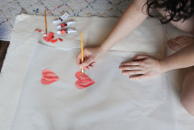 High angle view of woman hand on table