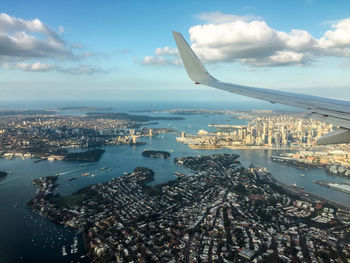 Aerial view of cityscape and sea against sky