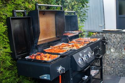 Food on barbecue grill in yard