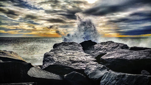 Panoramic view of rocks on sea against sky