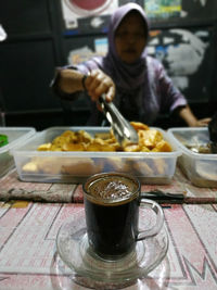 Midsection of man having food in restaurant