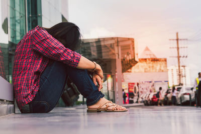 Young woman sitting outdoors