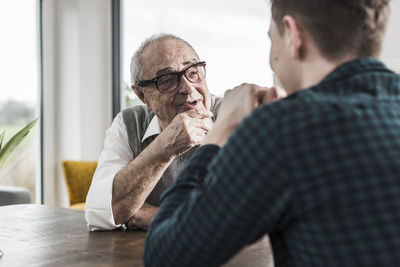 Portrait of happy senior man communicating with his grandson