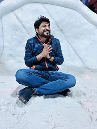 Boy sitting on ice