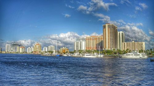 Buildings in city against blue sky