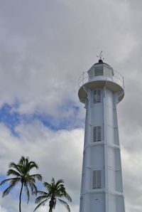 Low angle view of lighthouse against cloudy sky