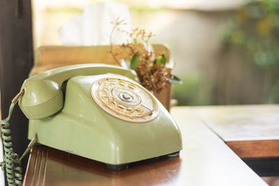 Close-up of rotary telephone on table at home