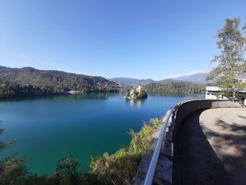 Scenic view of lake against clear blue sky