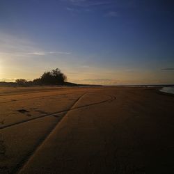 Scenic view of land against sky during sunset