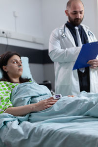 Female doctor examining patient at clinic