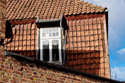 Low angle view of roof tile wall house