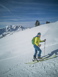 Full length of person skiing on snowcapped mountain