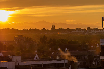 Panoramic view of colchester buildings against sky during golden summer sunset 