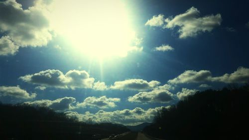 Scenic view of road against cloudy sky