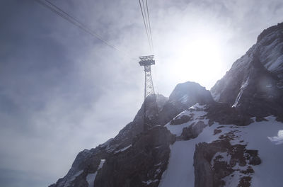 Low angle view of snowcapped mountain against sky