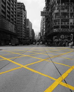 Yellow umbrella on road in city against sky