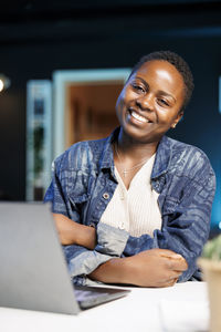 Young woman using laptop at office