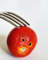 Close-up of strawberry over white background