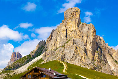 Low angle view of dolomites mountains against blue sky