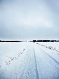 Snow covered field against sky