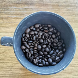 High angle view of coffee beans in bowl on table