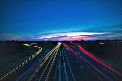 High angle view of light trails on highway at night