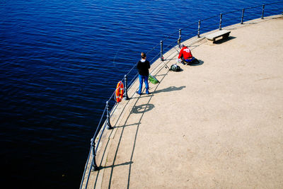 High angle view of people fishing at harbor