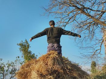 Low angle view of man standing against clear sky