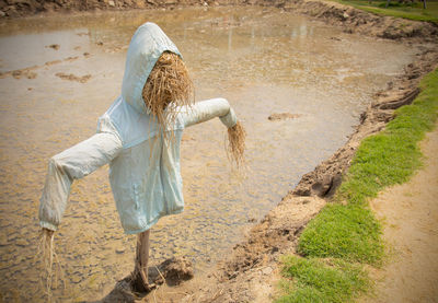 Rear view of woman standing in water