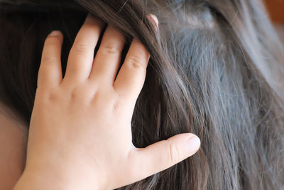 Close-up of girl with hand in hair